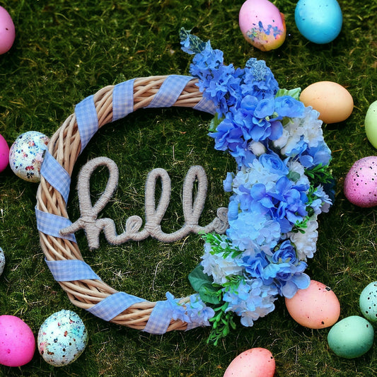 wicker wreath wrapped in gingham ribbon with blue and white roses and viburnum